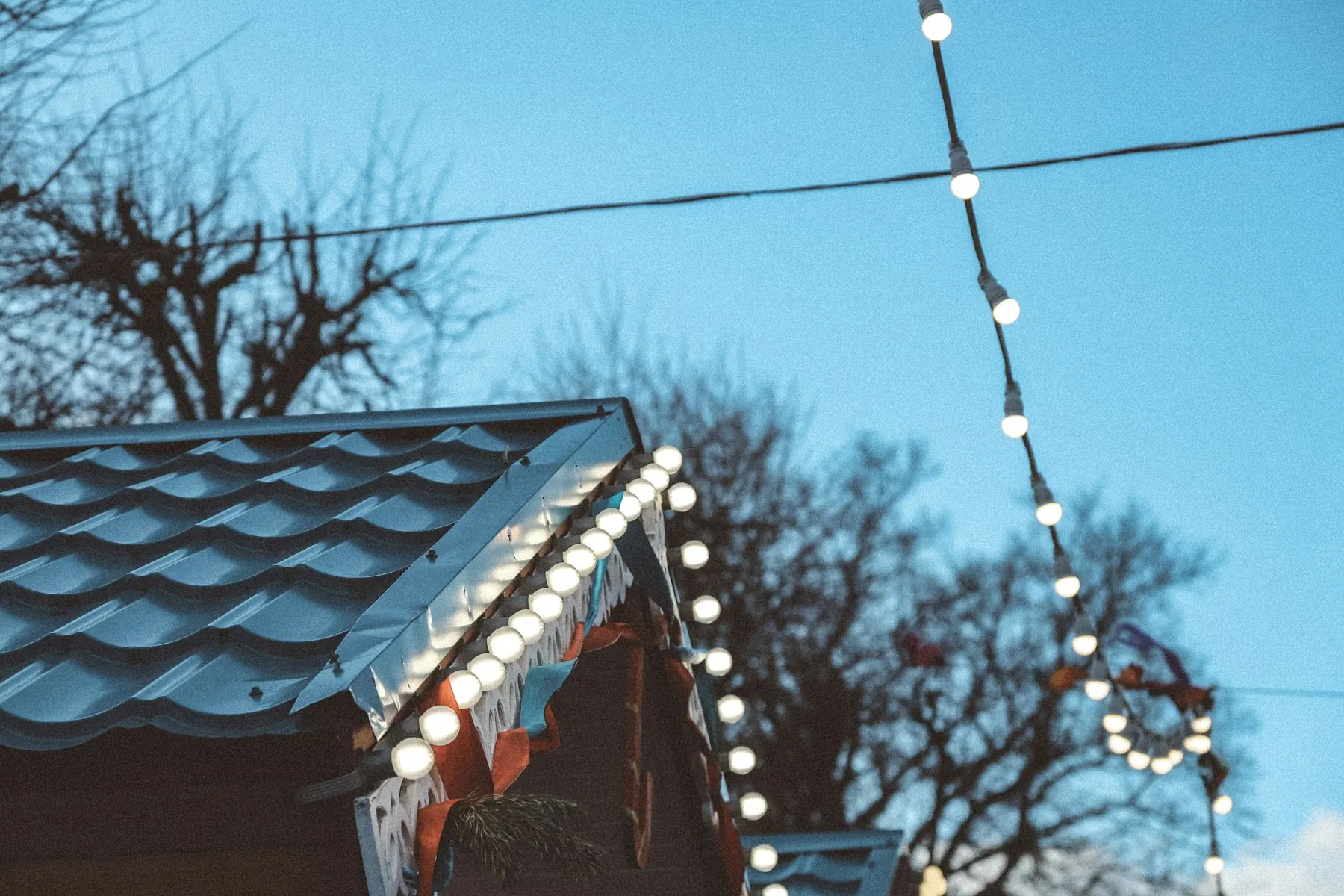 Close view of warm white C9 bulbs clipped along a gutter edge